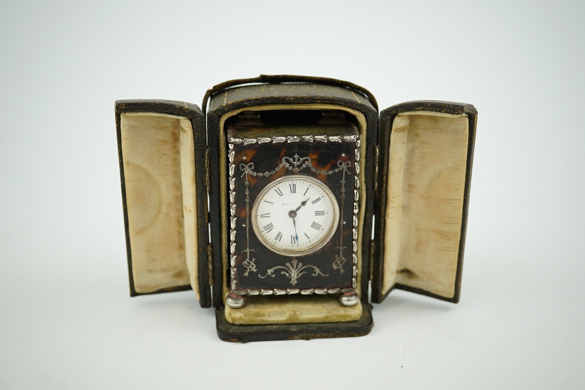 An Edwardian silver mounted tortoiseshell miniature carriage timepiece, by William Comyns